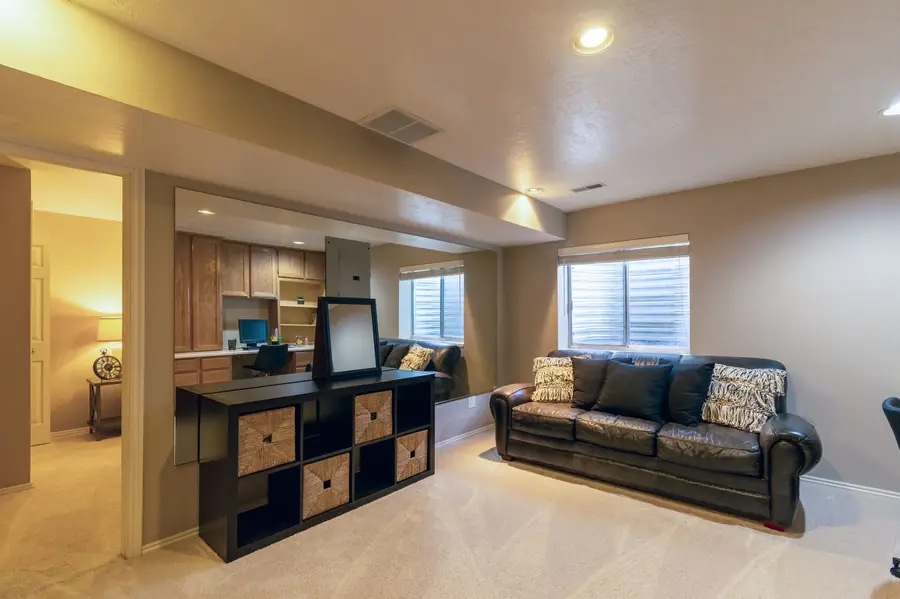 Finished basement family room with a sofa and carpet