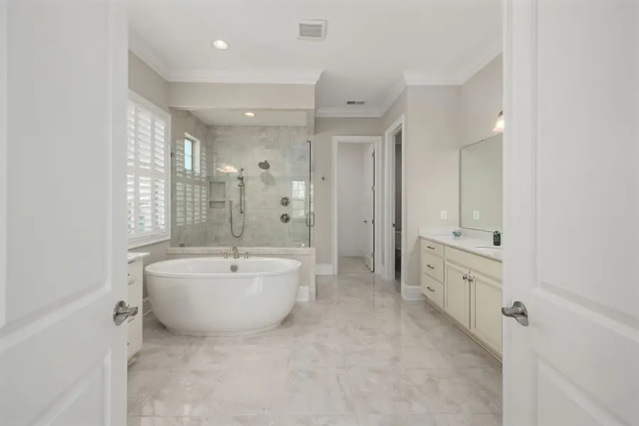 Remodeled bathroom with a freestanding tub and glass shower
