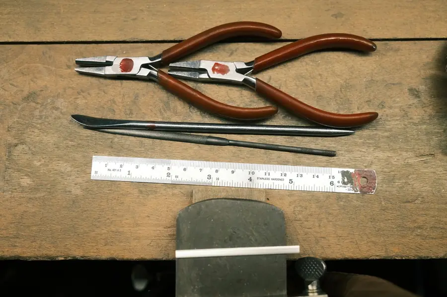 Hand tools laid out on a wooden workbench